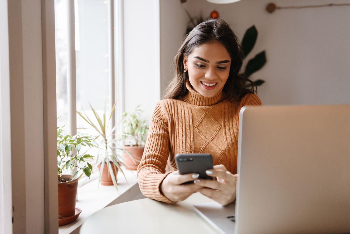 Woman Sitting in Cafe Using Laptop Computer